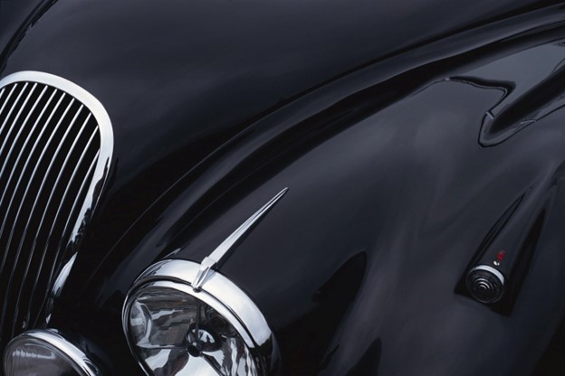 Black Jaguar sports car hood showing a grill and headlight